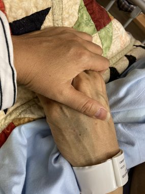 loss of a husband | FAP News Today | Jaime holds hands with her husband, Aubrey, in the hospital during his final days on earth.