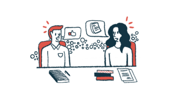 Two people sit at a table sharing ideas.